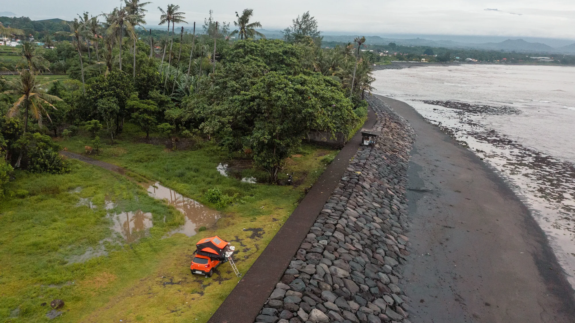 Camper parked by the seawall at dawn